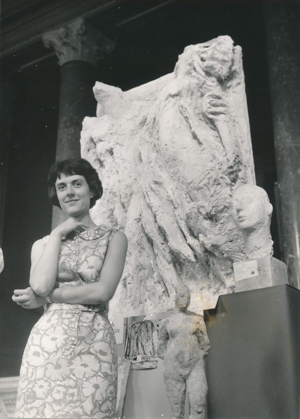 A young Jacqueline Georges Deyme beside a large plaster high relief, 1960s